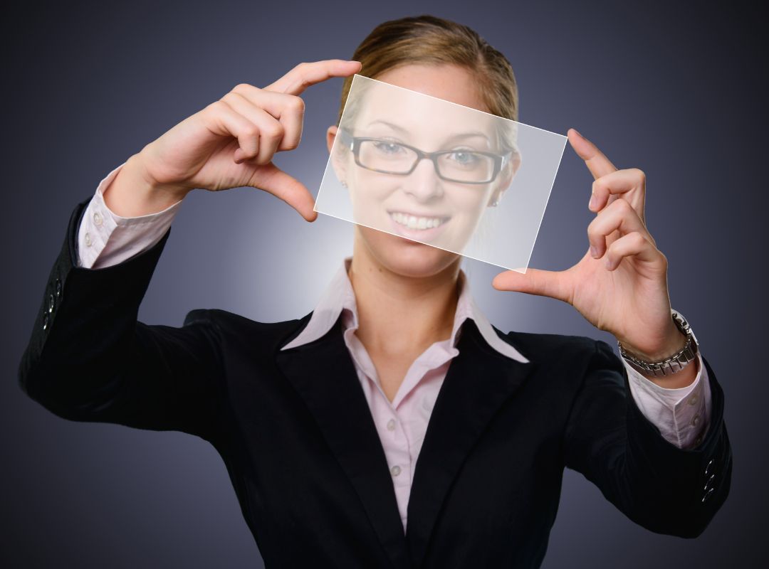 Woman executive holding a transparent sheet out in front of her face