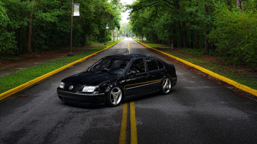 Black Volkswagen Jetta on a lonely road