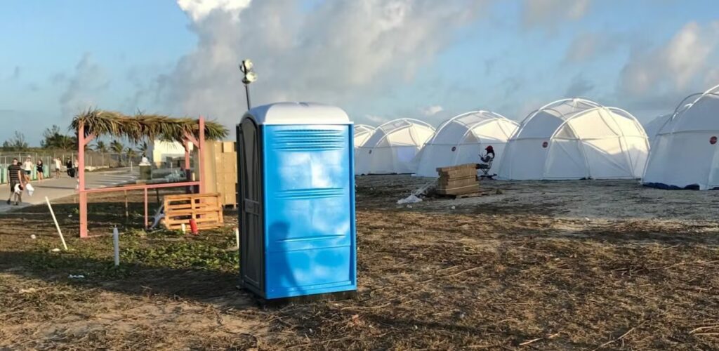 A Port-a-Potty stands outside FEMA tents at the Fyre Festival